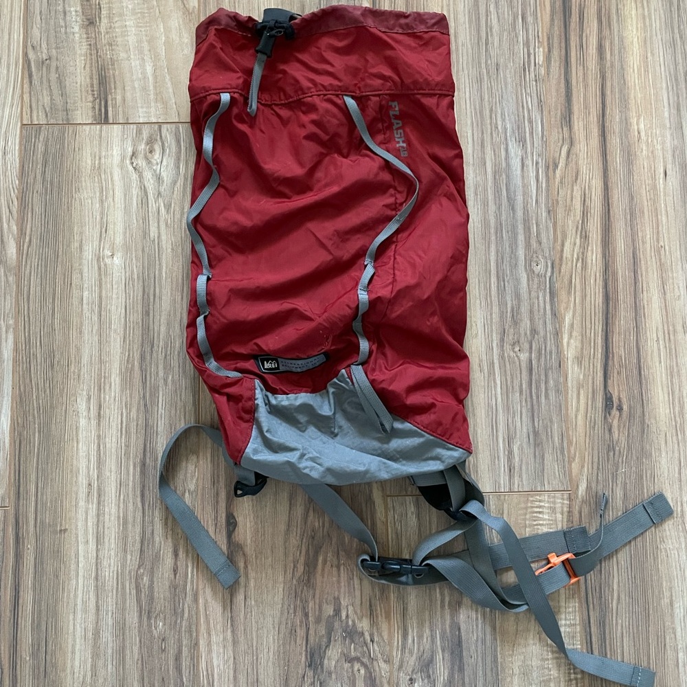 REI small red backpack, holds camelback water bottles, inside pocket